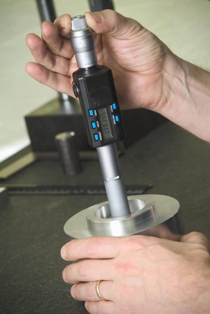 CNC machining tolerance measurement using caliper precision metal part