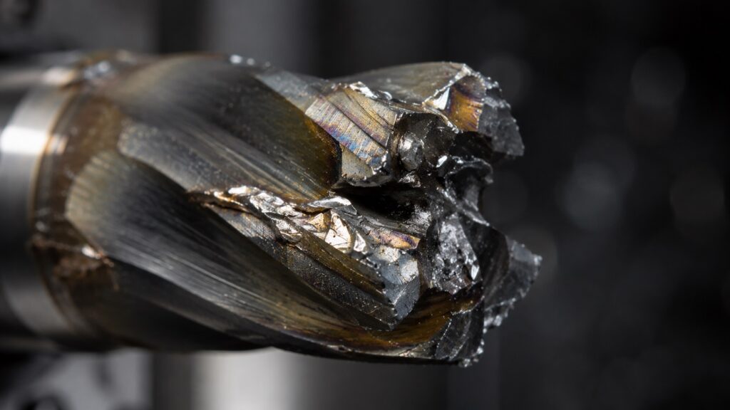Broken carbide end mill with welded aluminum chip buildup