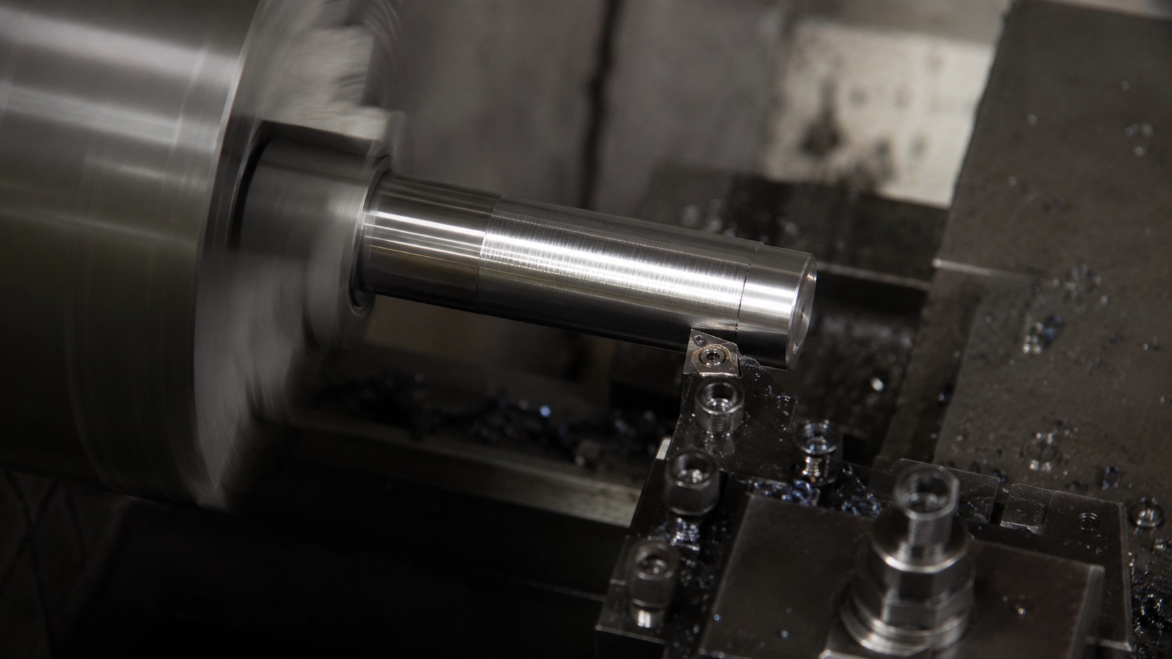 CNC chatter marks forming on a turned steel shaft during lathe machining